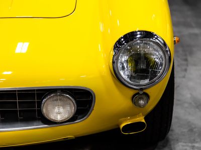 A Close Up Of The Front Of A Yellow Sports Car