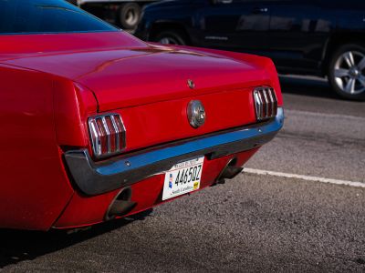 A Red Mustang Parked In A Parking Lot
