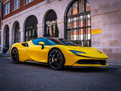 A Yellow Sports Car Parked In Front Of A Building