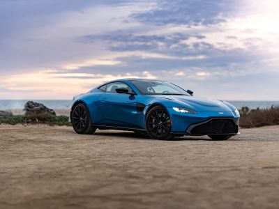 Blue Porsche 911 On Brown Sand Under White Clouds During