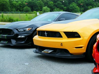 Parked Yellow Ford Mustang Coupe And Black