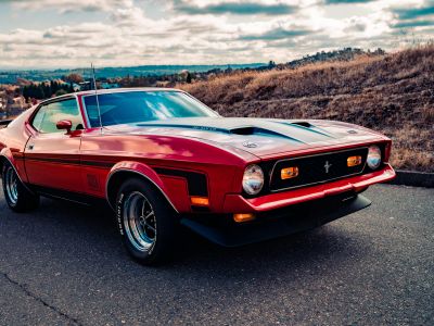 Red Chevrolet Camaro On Road During Daytime