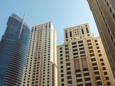 A Group Of Tall Buildings Sitting Next To Each Other