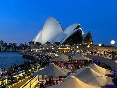 A Large Crowd Of People At A Concert With Sydney Opera