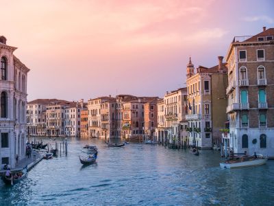 Photo Of Gondolas On Body Of Water Between Buildings