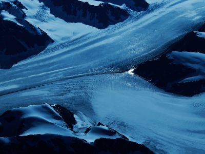 An Aerial View Of A Snow Covered Mountain Range