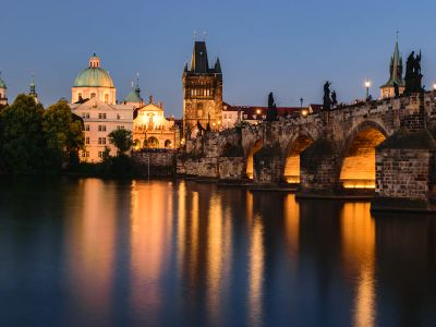 A Bridge Over A Body Of Water With Buildings In The
