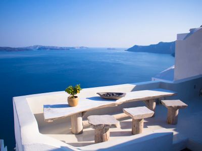 Bench And Dining Table Near Body Of Water Under Calm Sky