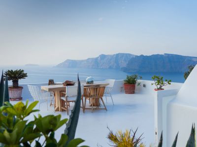 Brown Wooden Table And Chairs On White Concrete Floor