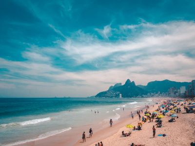 Group Of People Sunbathing On Beach