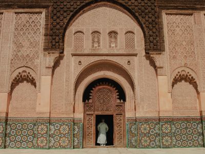 Person Standing On Opened Door Of Building