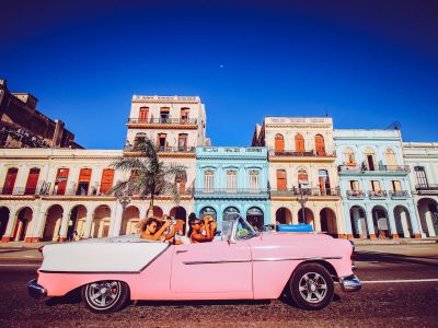 Pink Convertible Car Parked Near Beige Concrete Building