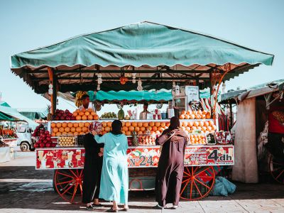 Three Women In Front Of Fruit Carriage Stand