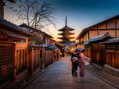 Two Women In Purple And Pink Kimono Standing On Street